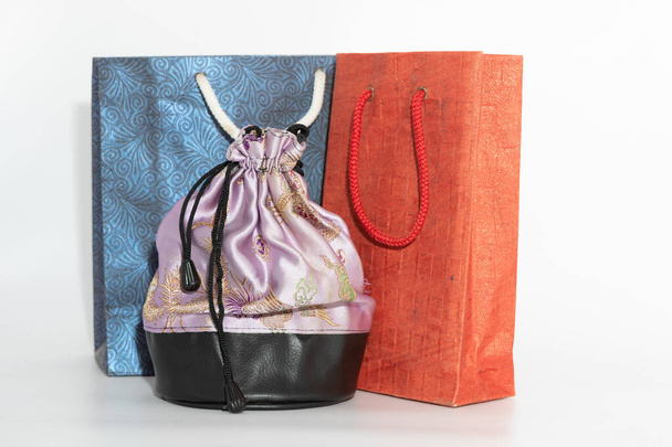 Colorful paper carry bags and a silk cloth pouch - Фото, зображення