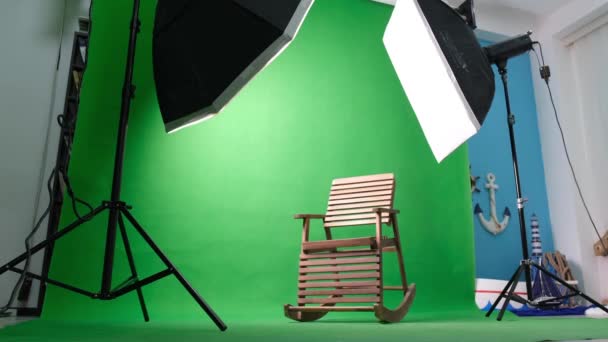 Фото или видео студия с двумя гексагоновыми огнями студии. Зеленый экран и кресло-качалка - Кадры, видео