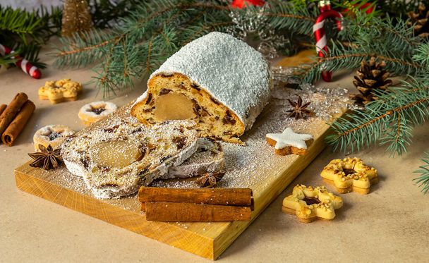 Stollen with marzipan.Traditional German Christmas cake or fruit bread with holiday decorations. - Photo, Image