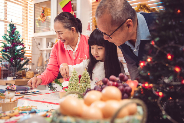 Thanksgiving or christmas Celebration Asian  Family Dinner Concept.Happy family having holiday dinner. father mother and daughter, having dinner at home. elderly parents during the celebration . - Φωτογραφία, εικόνα