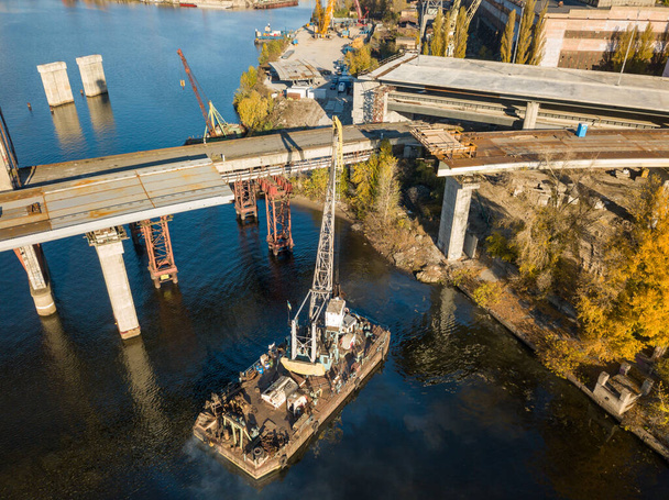 Bridge construction site in Kiev. Sunny autumn morning. Aerial drone view. - Фото, изображение