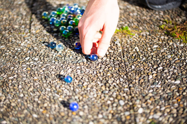 Playing marbles, old children's game, colorful balls - Photo, Image