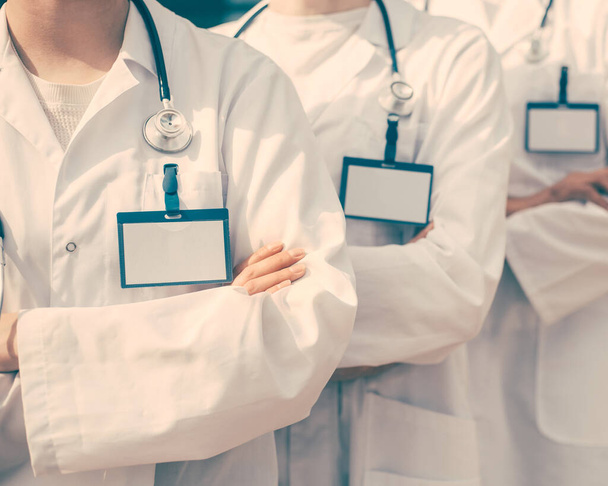 close up. group of medics with blank badges standing in a row. - Foto, afbeelding
