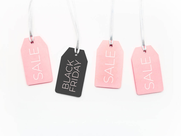Pink and black tags on white background. Glamorous labels on silver threads. Black Friday sale and shopping. Top view, flat lay. - Zdjęcie, obraz