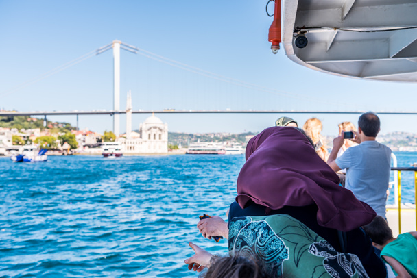 Turistas em um navio de cruzeiro desfrutando de uma excelente vista da ponte do Bósforo e da paisagem marítima no estreito de Istambul, conceito de férias - Foto, Imagem