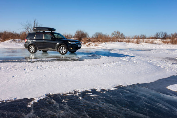 Khabarovsk, Russia - January 4, 2020: Black Subaru Forester at frozen lake ice. - Foto, imagen