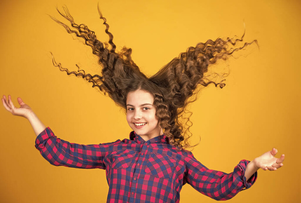 Freedom self expression. Small girl hairdresser salon. Brushing long hair. Little child curly hair. Fashion and beauty. Enjoying shiny curls. Balm for styling. Hairstyle party. Hairdresser supplies - Fotoğraf, Görsel