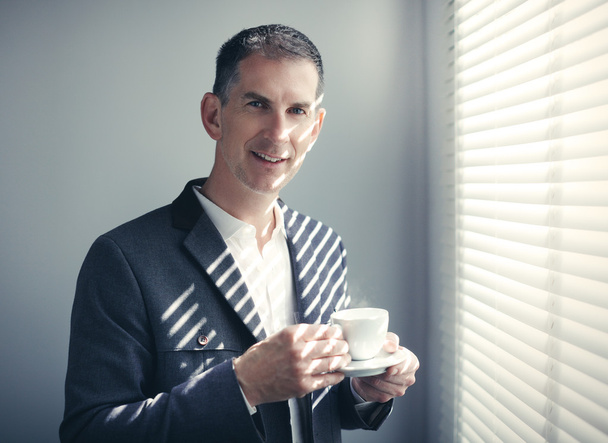 Portrait of businessman with cup of coffee - Foto, Imagen
