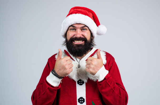 Christmas fun. merry christmas. cheerful bearded man in santa claus costume. brutal hipster celebrate xmas party. winter holiday preparations. present and gift shopping sale. happy new year - Foto, Bild