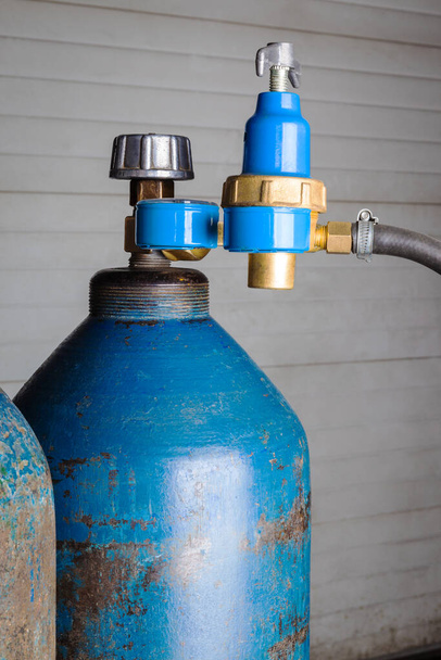 blue gas cylinder with regulator close-up - Fotoğraf, Görsel