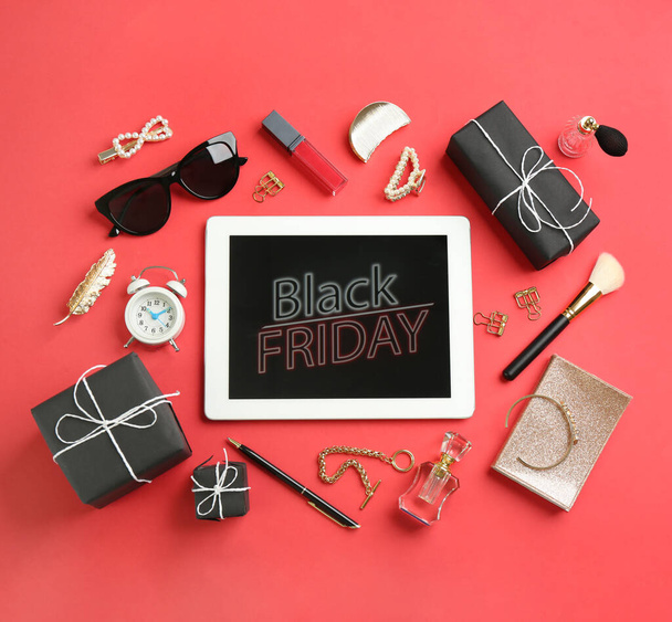 Flat lay composition with tablet, gifts and accessories on red background. Black Friday sale - Foto, immagini