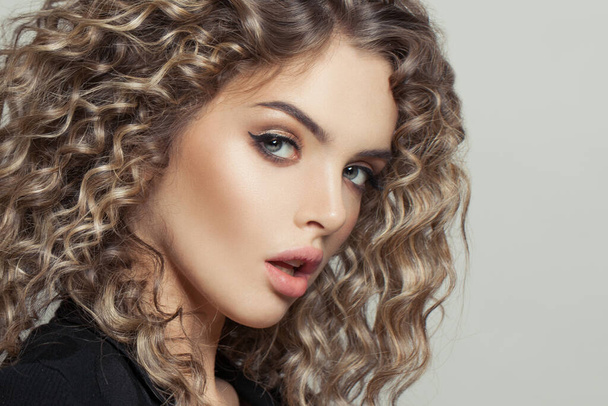 Nice model woman with curly hair on white, fashion beauty portrait - Photo, Image
