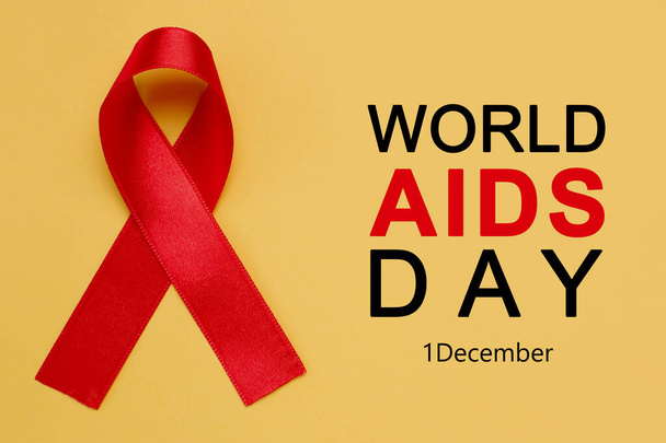 World AIDS Day poster. Red awareness ribbon and text on yellow background - Foto, immagini