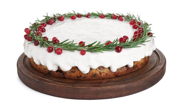 Traditional Christmas cake decorated with rosemary and cranberries isolated on white - 写真・画像