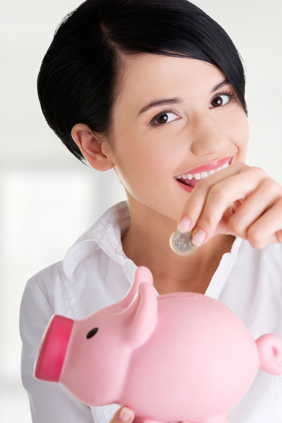 Happy business woman with her savings  - Foto, Imagen
