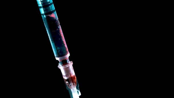 Taking blood with a syringe. Addicts infected blood - Foto, afbeelding