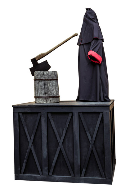 Палач черный мантийный капюшон, изолированный на белом. Средневековый публичный палач на месте отделения головы от тела обезглавливает топором пень - Фото, изображение