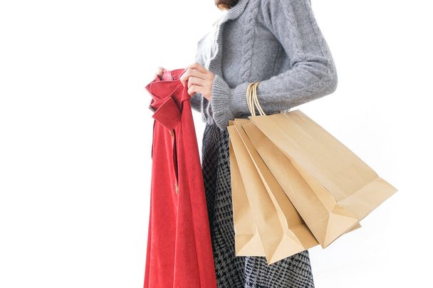 Γυναίκα αγοράζει ρούχα σε λευκό - Φωτογραφία, εικόνα