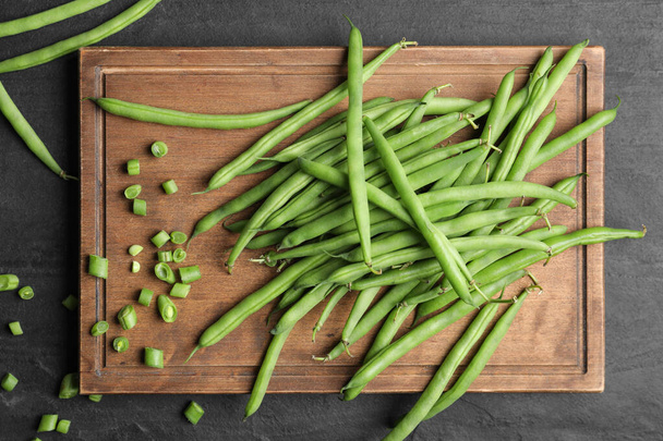Fresh green beans on black table, flat lay - Fotografie, Obrázek