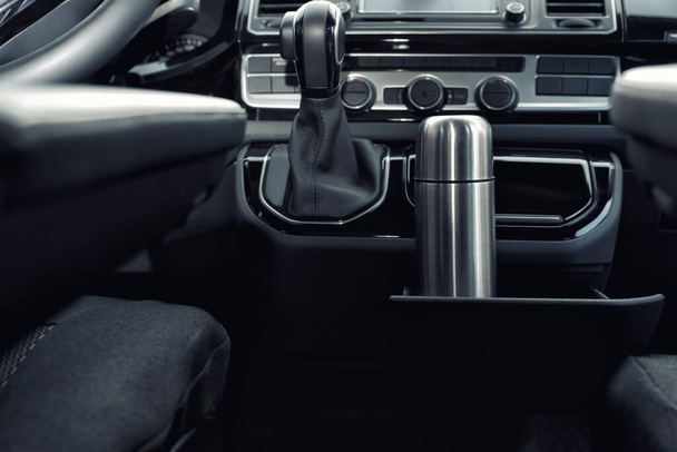 Silver thermos in holder inside of car - 写真・画像