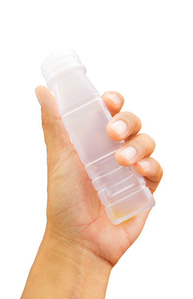 ręka trzyma butelkę na białym tle - Zdjęcie, obraz