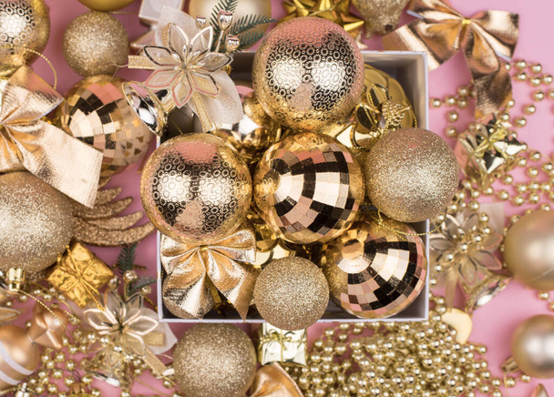 lots of Golden Christmas balls on pink background, New Year background bokeh. - Zdjęcie, obraz