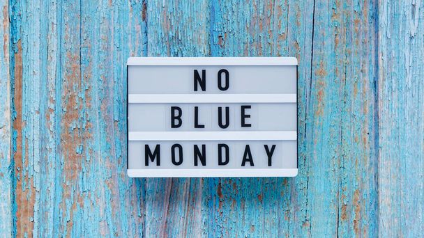 Blue monday day banner concept. White board with text no blue monday on blue wooden background, top view, flat lay - Photo, Image