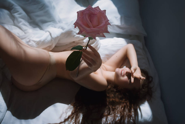 Stock photo -  Girl under the covers in her bed - Valokuva, kuva