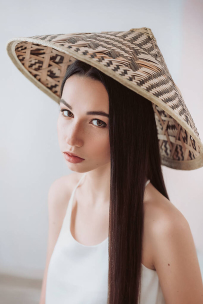 Portrait of beautiful young girl with natural beauty. Girl in bamboo vietnamese hat - Fotografie, Obrázek