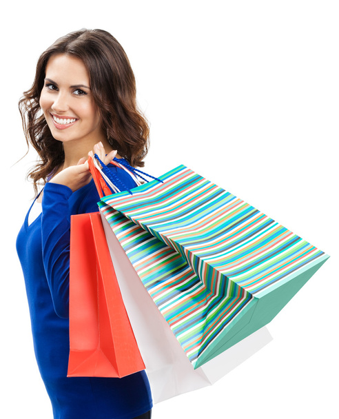 Young happy woman with shopping bags, isolated - Fotó, kép