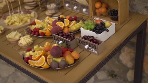 buffet de bodas con aperitivos de frutas en una mesa de madera - Metraje, vídeo