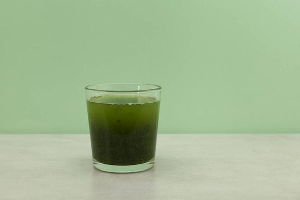 Herbal ayurvedic drink of moringa leaves. Healthy eating. Green leaves have medicinal properties. - Fotoğraf, Görsel