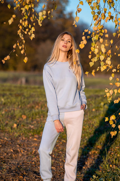 Beautiful woman in autumn clothes outdoor, blue sky background - Valokuva, kuva