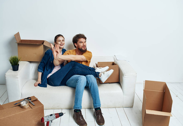 young couple in the room housewarming boxes with things moving emotions fun - Photo, Image