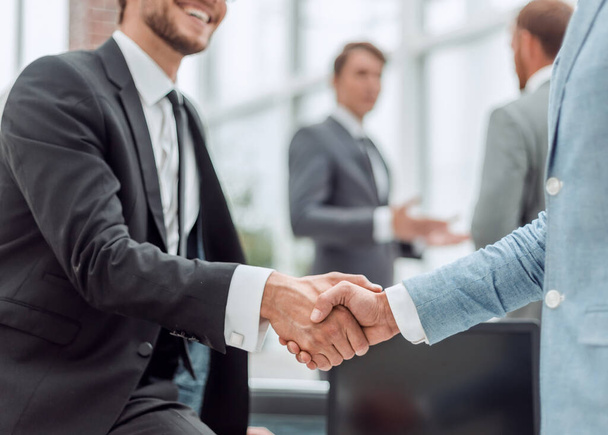 happy young businessman shaking hands with his business partner - Фото, зображення
