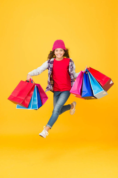 Every purchase delivered to you. Energetic child carry shopping bags. Handle paper gift carrier bags. Pack and package. Wholesale prices. Sale and discount. Shop till you drop - Photo, image