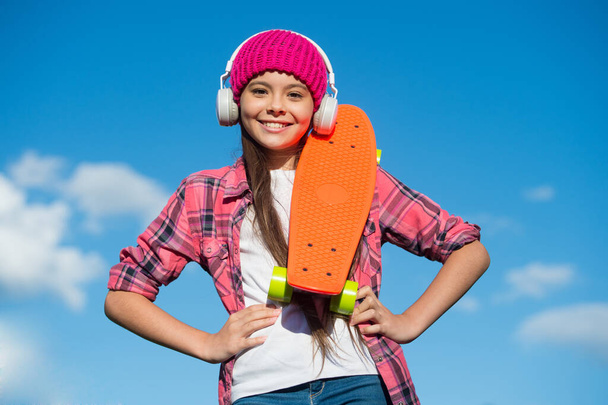 Active lifestyle. Active girl skater hold penny board sunny sky. Action sport. Recreational activity. Healthy life. Skateboarding and transportation. Summer vacation. Outdoor adventure - Foto, Bild