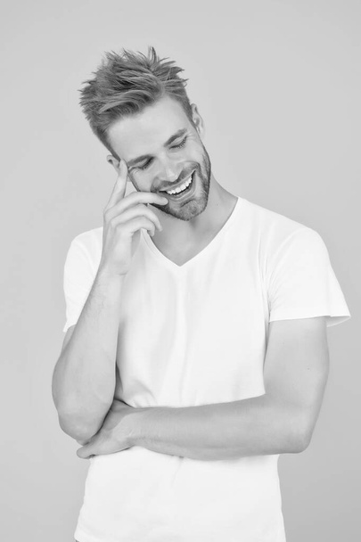 Psychology concept. Emotional handsome guy. Sexy handsome confident young man standing in white shirt. Summer and spring collection. Emotional intellect. Face expression. Emotional means alive - Фото, зображення