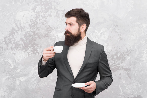 Business people fashion style. Smart casual style clothes for office life. Best coffee served for him. Specialty coffee. Man handsome bearded businessman hold cup of coffee. Coffee break concept - 写真・画像