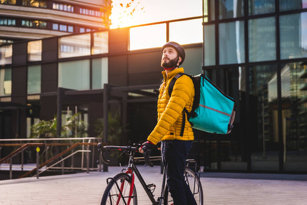 Food delivery service, rider delivering food to clints with bicycle - Concepts about transportation, food delivery and technology - Фото, зображення