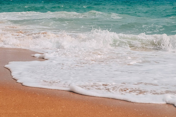 Ondas turquesas con espuma blanca a orillas de la playa de Benagil en portuga - Foto, imagen