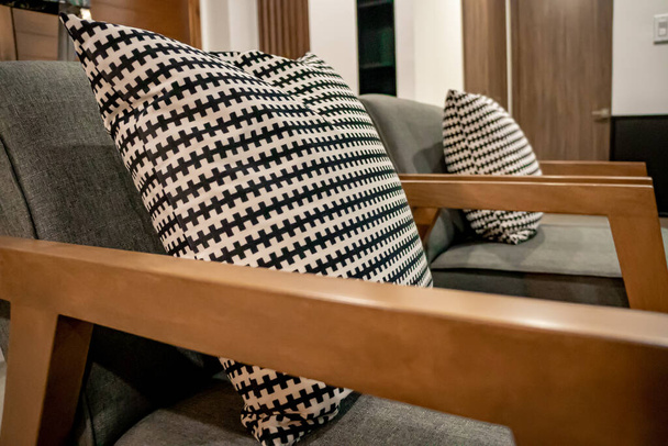 Luxurious wooden chairs with black and white cushions for interior decoration. - Foto, afbeelding