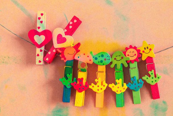 Clothespin colorful hearts on old wood. - Photo, Image
