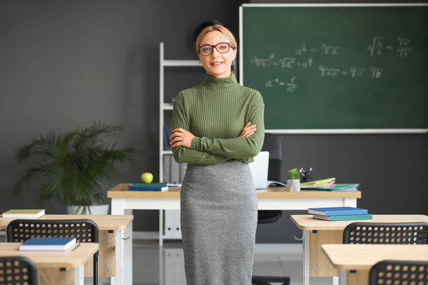 Mature female teacher in classroom - Фото, зображення