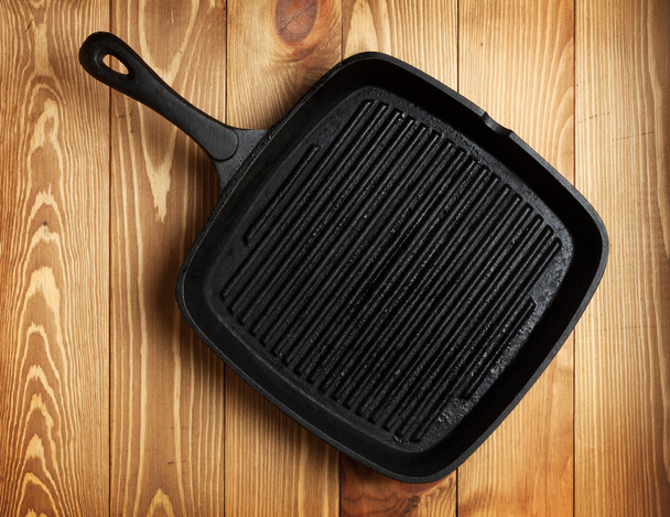 Frying pan on wooden table background - Foto, Bild