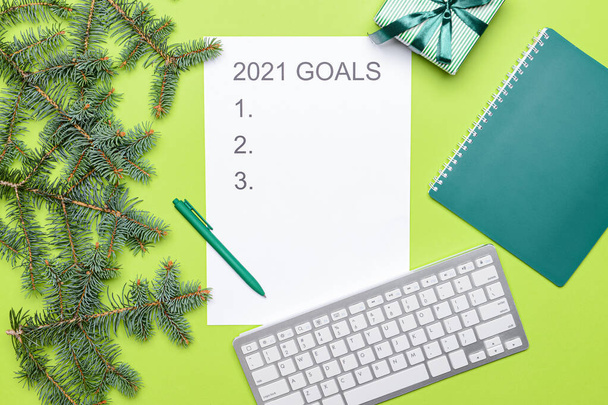 Empty to do list on 2021 year with gift and computer on color background - Photo, Image