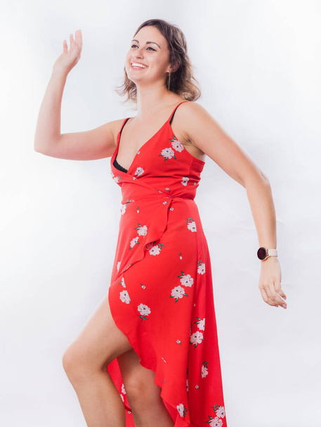 Beautiful young woman in red dress dancing - Foto, Imagem