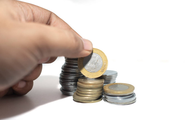 Рука с монетами индийской валюты изолированы на белом фоне - Фото, изображение
