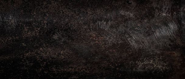 Rough rusty and scratched metal texture. Dark or black background - Photo, Image