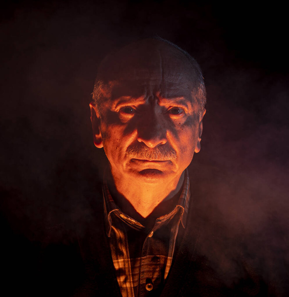 Portrét děsivě vypadající muž přes tmavé pozadí - Fotografie, Obrázek